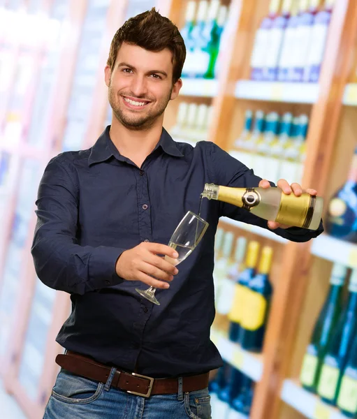 Young Man Pouring Champagne   — Stockfoto